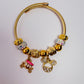 Pink carriage/mouse ear charm bracelet (gold)