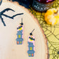 Pink haunted house earrings